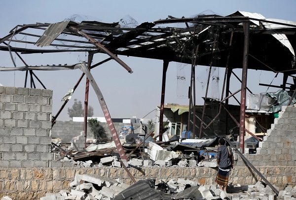 A guard inspects a factory damaged in last night's raid, January 20, 2019