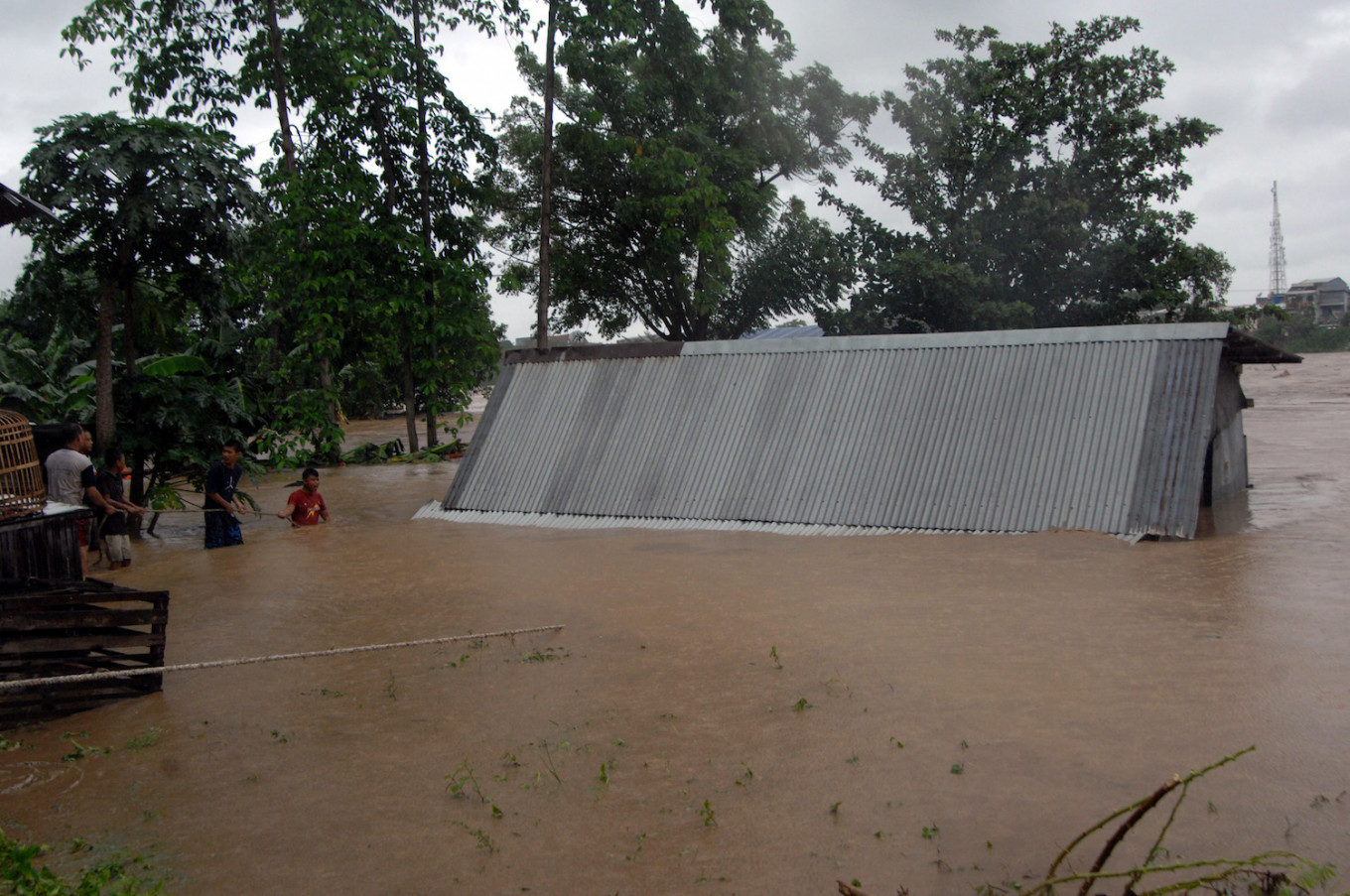 Click to enlarge Residents try to hold on to a house