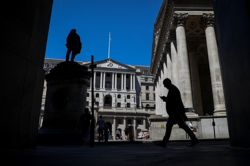A pedestrian passes the Bank of England in the City of London.
