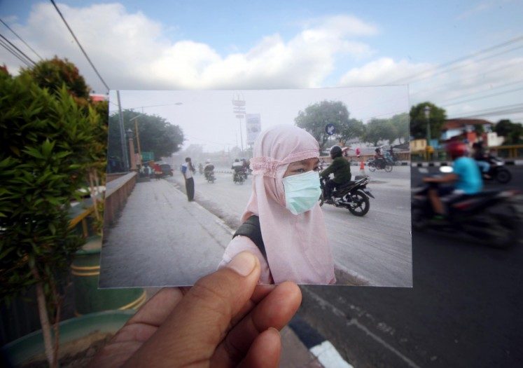 Click to enlarge Dust has settled: A student wears a mask to
