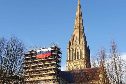 Supreme Trolling: One year on from Skripal false-flag chemical attack, enormous Russia flag mounted on Salisbury cathedral