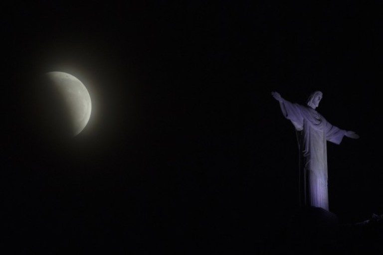 A blood moon rises above the Christ the Redeemer statue during a lunar eclipse in Rio de Janeiro, Brazil