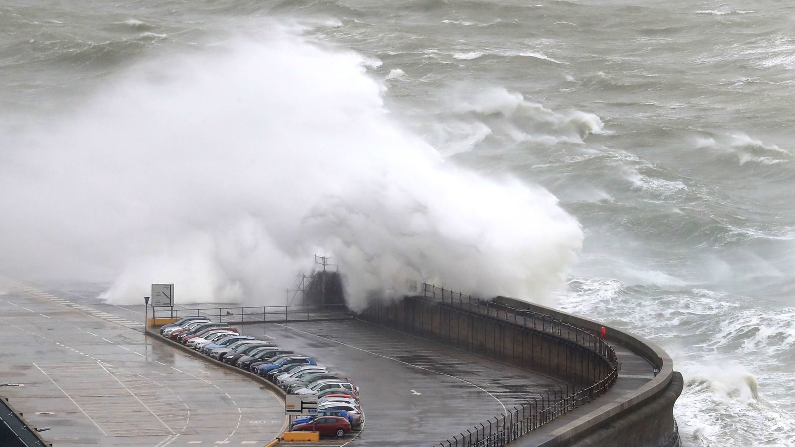 Waves crash onto the harbour in Dover, UK