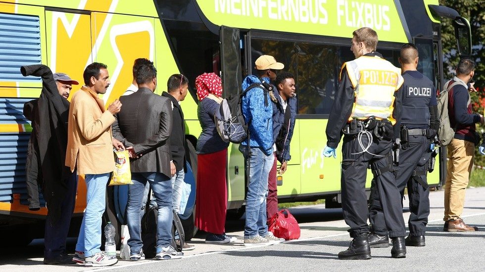 Click to enlarge German police officers check the passports of bus passengers on the highway from Austria.