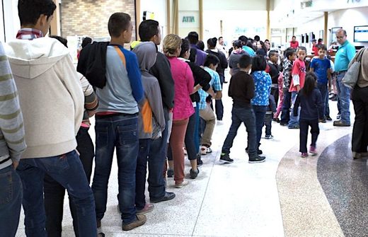 Click to enlarge Migrants at agency