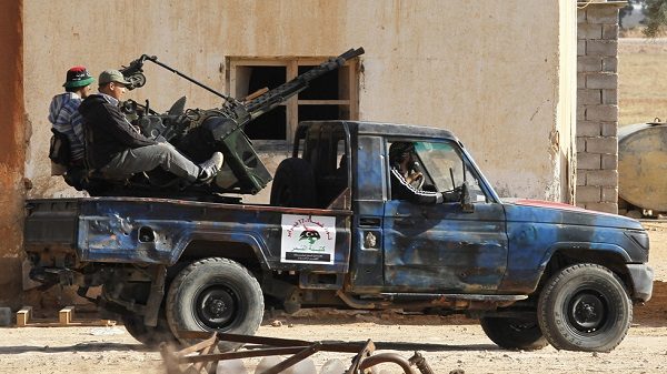Libyan rebel fighters drive a pickup truck in May, 2011