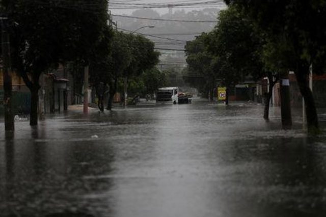 A truck stuck at a flooded street during heavy rains in the Fazenda Botafogo neighbourhood in Rio de Janeiro, Brazil