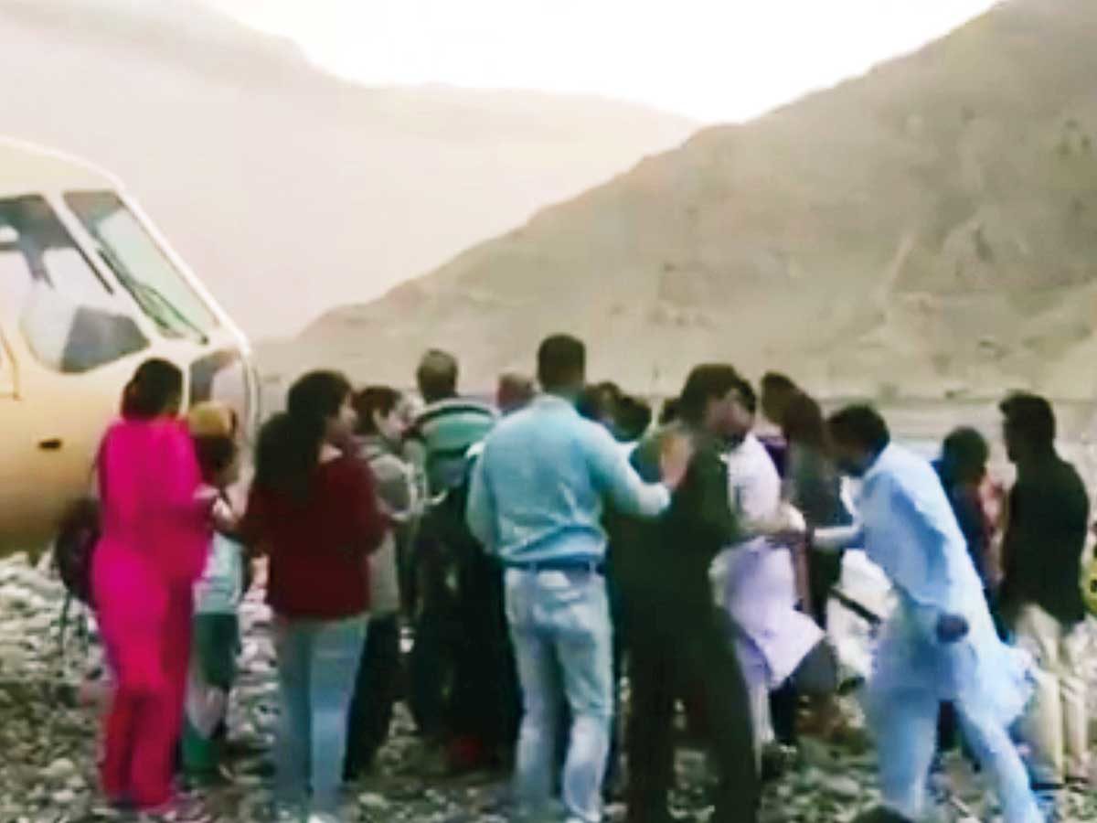 People scramble to get into the rescue helicopter during the storm in the RAK mountains.