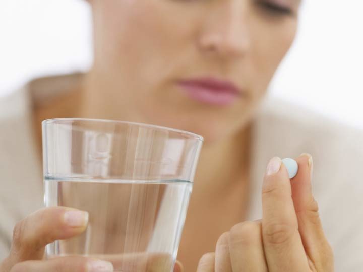 Click to enlarge woman taking pill