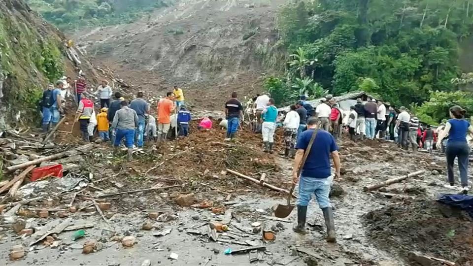 Grab taken from an AFP video showing people searching for others who might be trapped under
