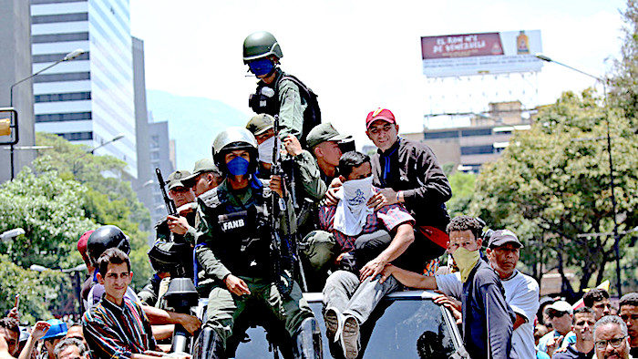 Click to enlarge Soldiers atop car