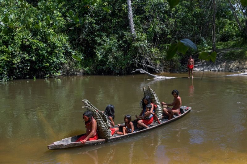 Waipai people crossing river in Brazil