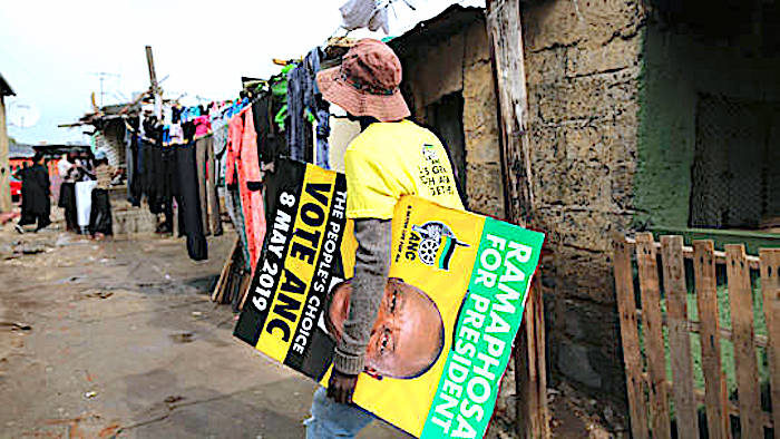 Click to enlarge Man carries ANC poster
