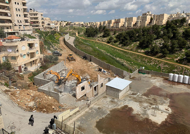 Click to enlarge Israel demolishing Palestinian building