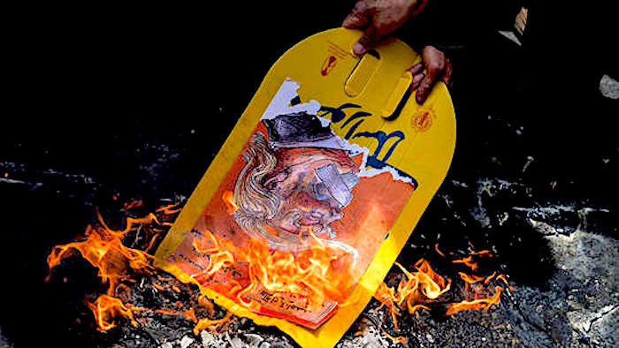 Click to enlarge Trump pic burned