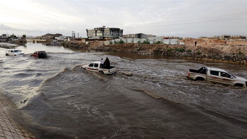 Vehicles drive through a flooded road following heavy rains in Sanaa, Yemen.
