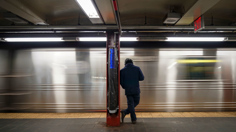 Click to enlarge man waiting for subway