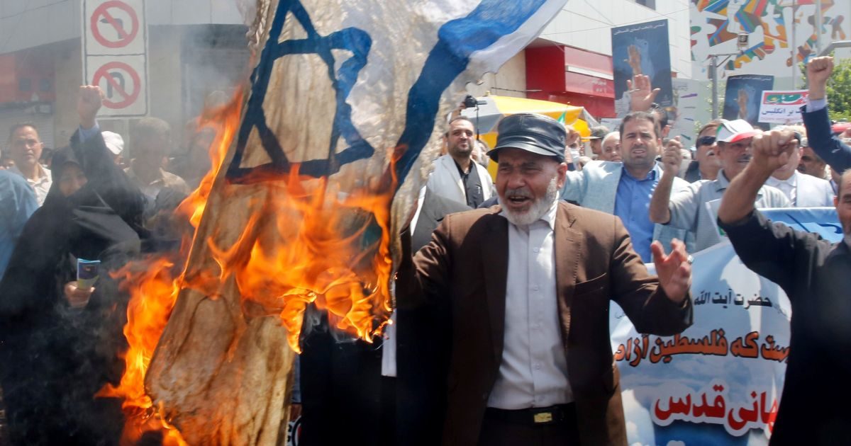 Iran protesters burn Israel flag