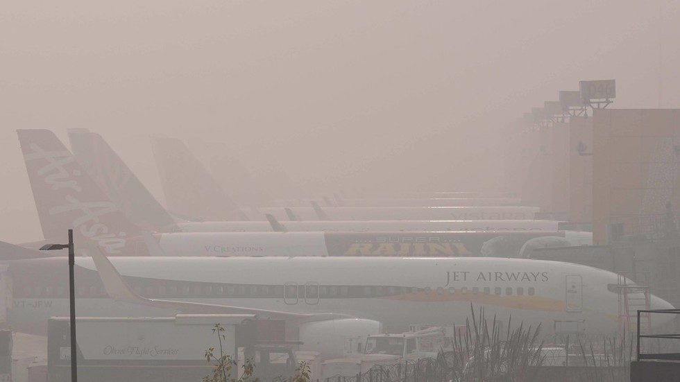Planes are seen at the New Delhi airport on a smoggy day