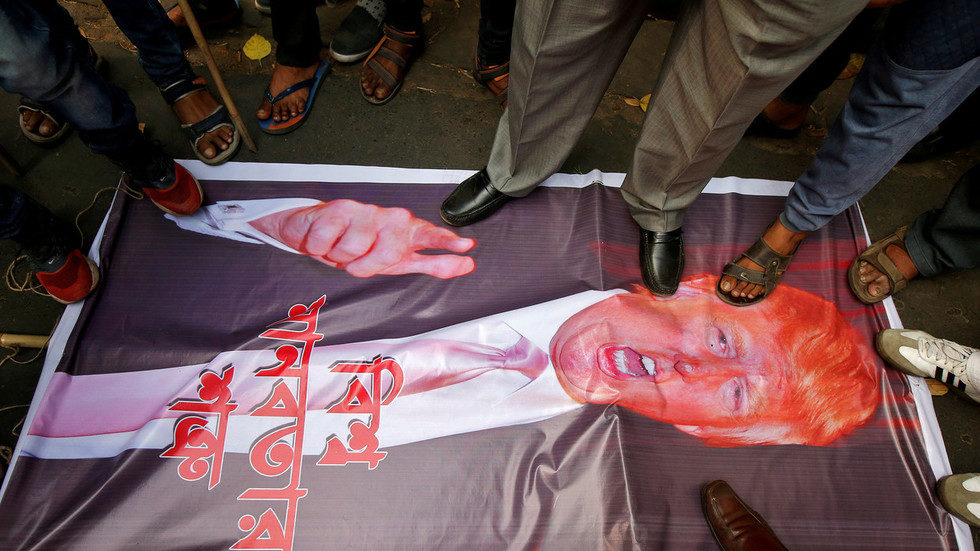 Click to enlarge Trump poster being stepped on