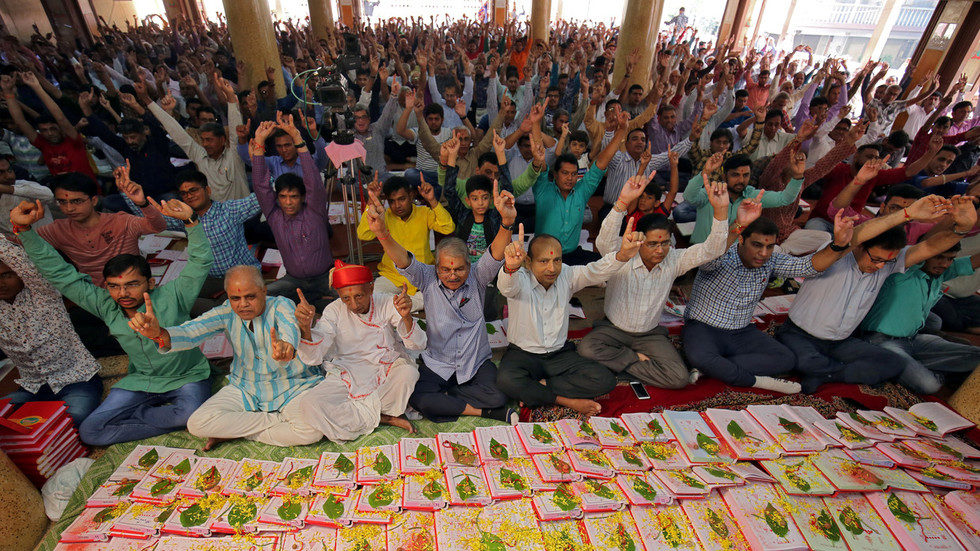 Click to enlarge Indian businessmen pray in front of their record-keeping books in worship to the Hindu deity of wealth goddess Lakshmi