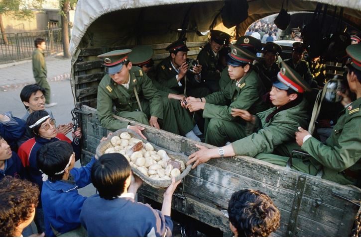 Tianenment protestors give food to police