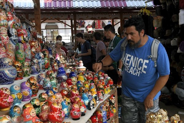 Click to enlarge Tourist choosing a souvenir