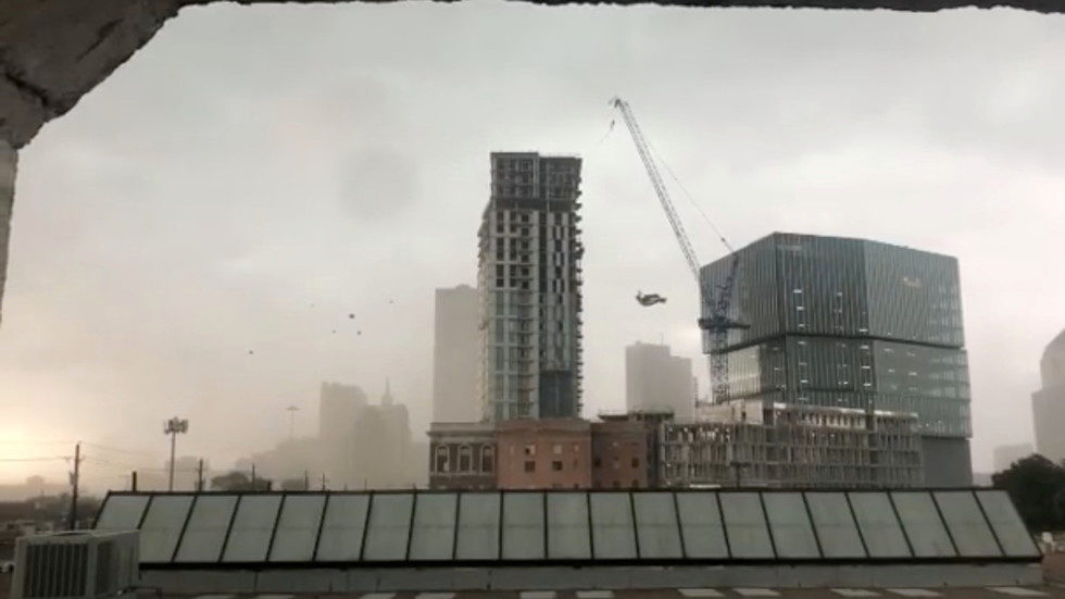 A construction crane sways before toppling amidst high winds in Dallas, Texas