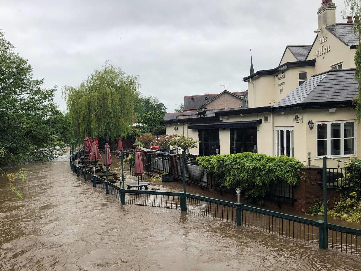 Flooding sweeps the beer garden at the Alyn Riverside Country Pub in Rossett, North Wales