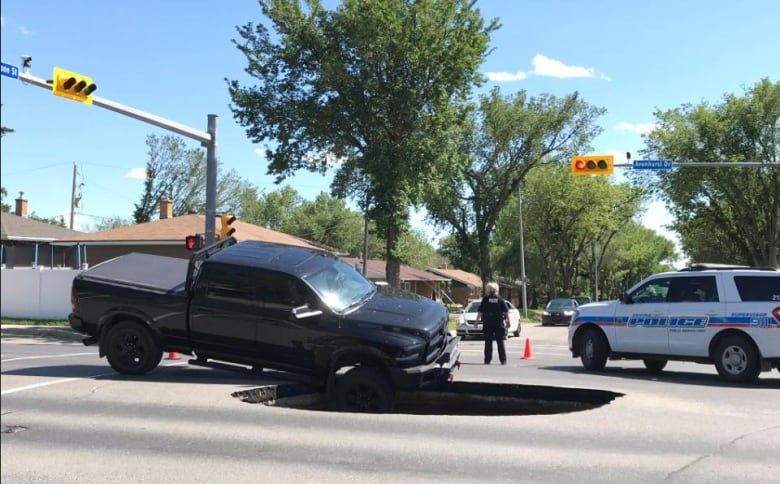 Click to enlarge A truck dipped into the hole,