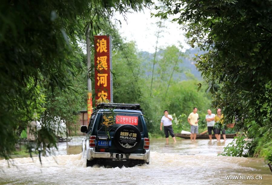 A vehicle runs in the flooded areas in Chang'an Town, Rong'an County, south China's Guangxi Zhuang Autonomous Region, July 9, 2019.