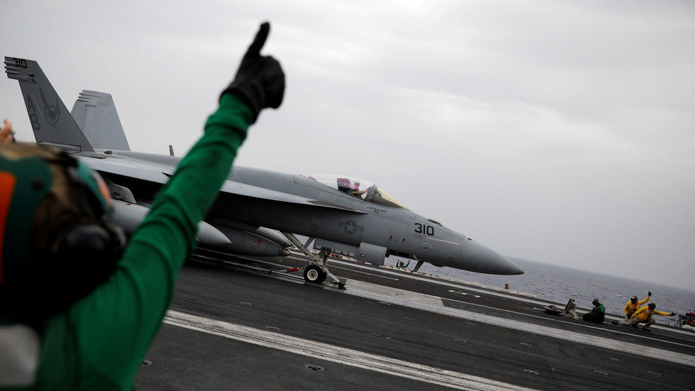 An F/A-18 fighter jet prepares to take off from the USS Harry S. Truman aircraft carrier