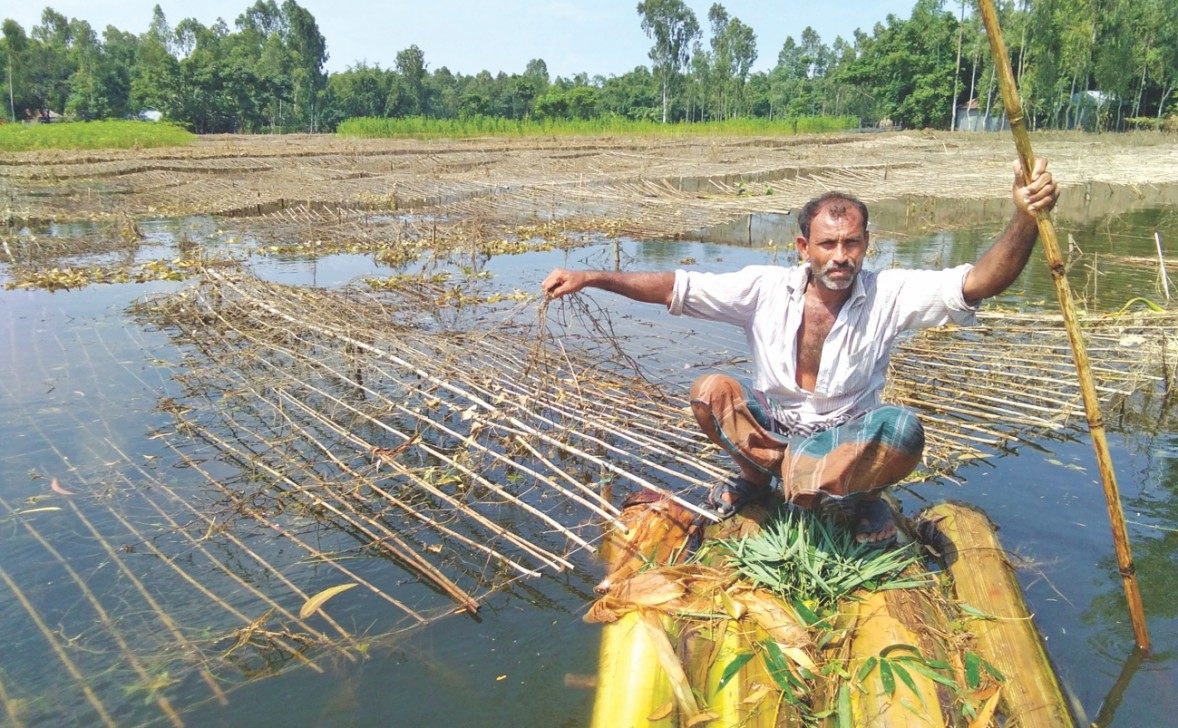 Click to enlarge Sitting on a raft made of banana trees,