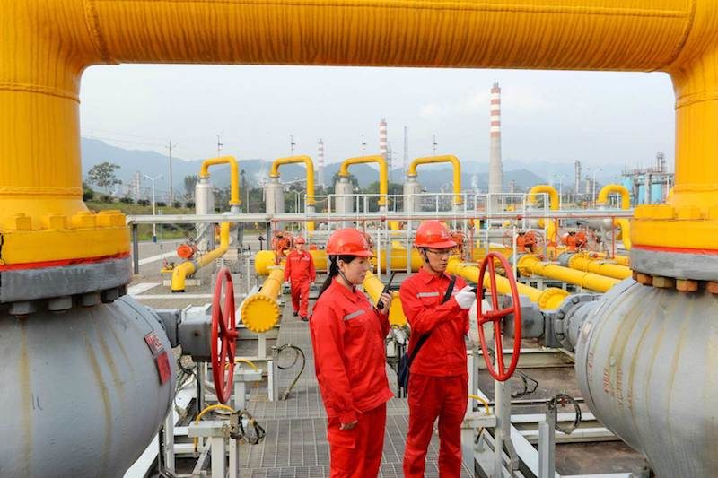 Workers inspect pipelines at a natural gas facility run by Sinopec in Dazhou, Sichuan province, China