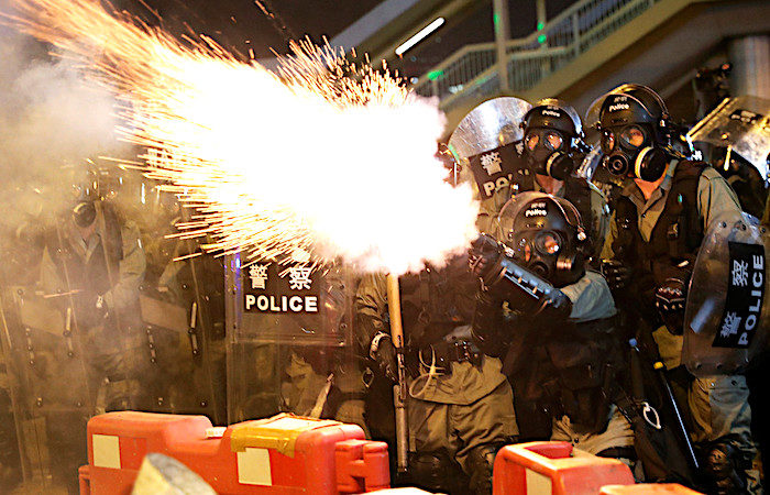 Click to enlarge Police tear gas