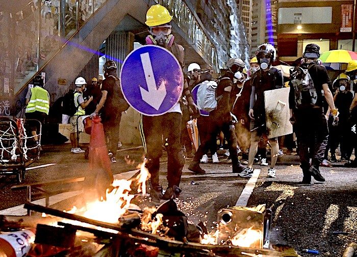 Click to enlarge Protester fires