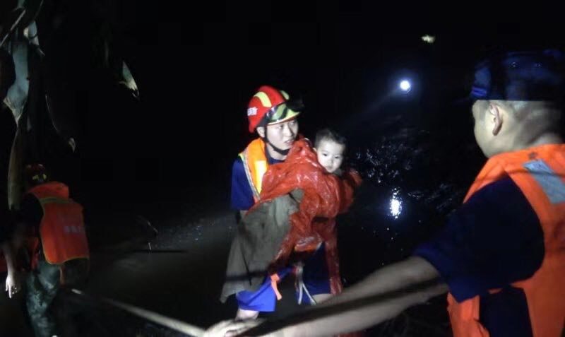 Rescuers pull tourists out of the flood which hit Duobi Gorge at Hefeng county in Hubei province on Sunday night.