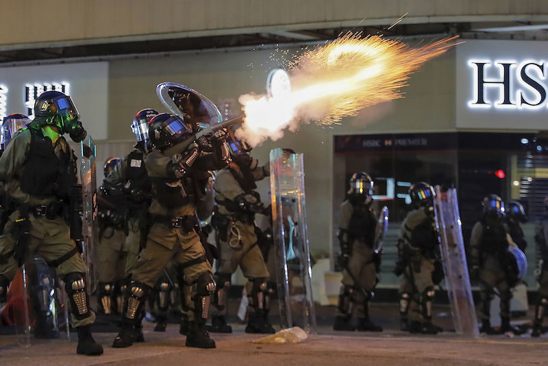 Click to enlarge Riot police fire tear gas