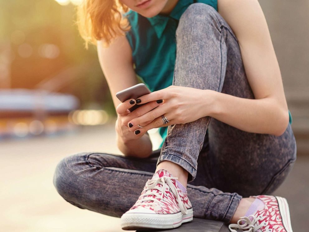 Click to enlarge girl using phone