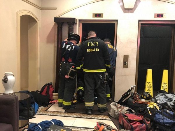 New York Fire Department members investigate an incident with an elevator in an apartment building