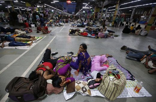 Stranded passengers in a railway station in Kolkata, India, in May after trains were canceled because of Cyclone Fani