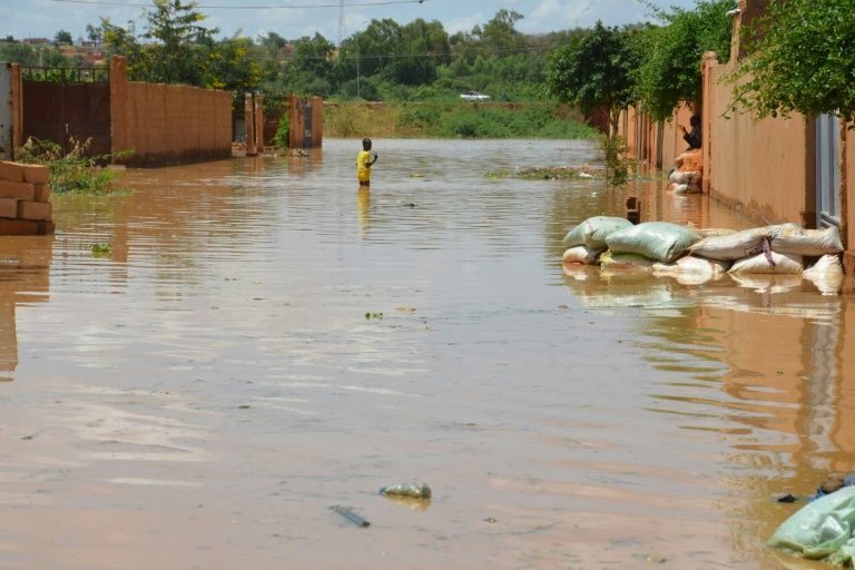 A child wades through muddy water early in September in the Kirkissoye district of Niamey, one of the worst hit by Niger river floods