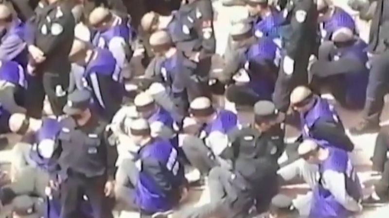 hundreds of blindfolded Uighurs