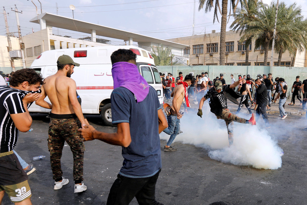 Demonstrators disperse as Iraqi police fire tear gas cannisters in Baghdad
