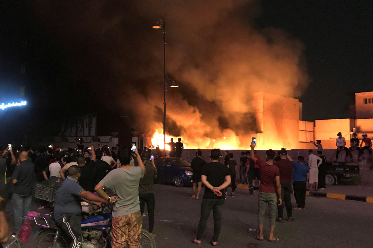 Click to enlarge Protesters set a government building on fire in Baghdad