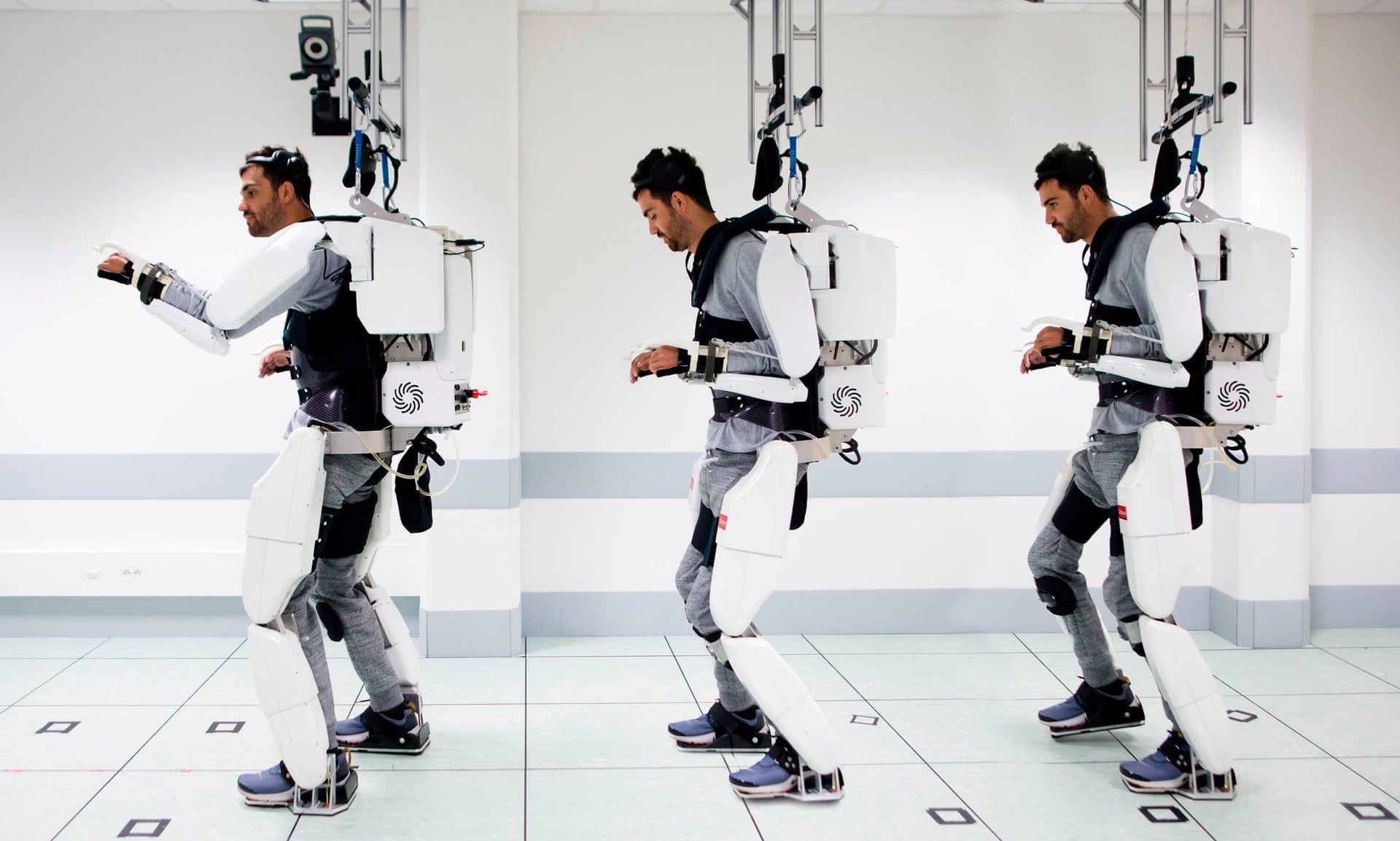 paralyzed man walking with exoskeleton