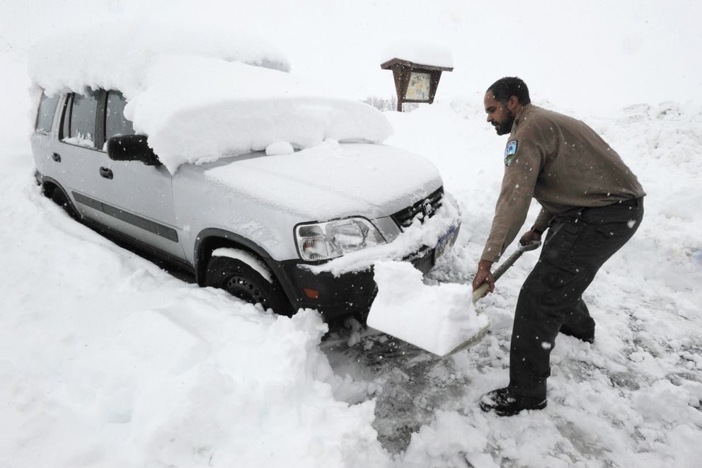 Click to enlarge Park Specialist Hobbes Barber with the Alaska State Parks shovels snow at the parking lot between Hatcher Pass Lodge and Independence Mine on Wednesday, Oct. 9, 2019.