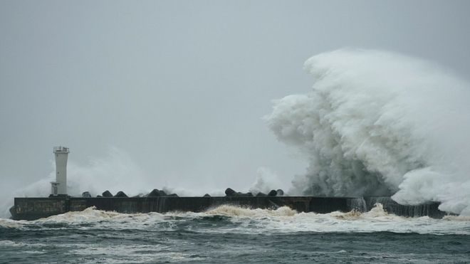 Huge waves are pounding sea walls as the storm approaches