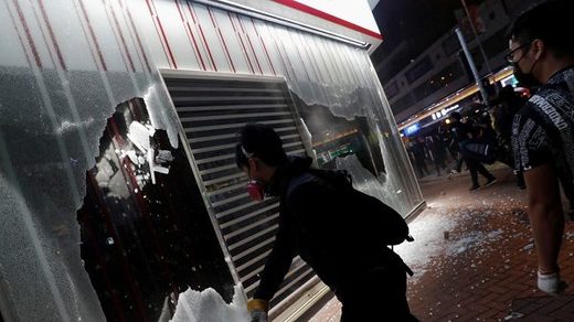 Protesters crashing bank window