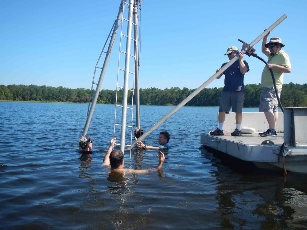 Collecting sediment cores from White Pond